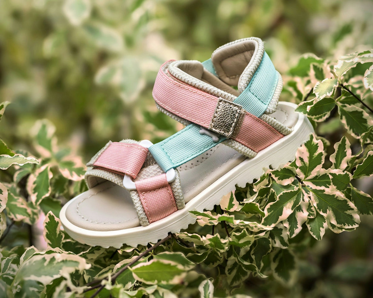 Colorful sandal rests amidst greenery